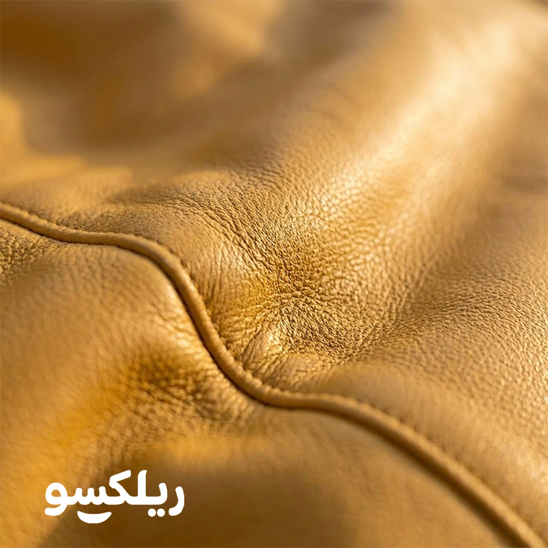 نمای نزدیک چرم مصنوعی مبل شنی تختی زرد ریلکسو